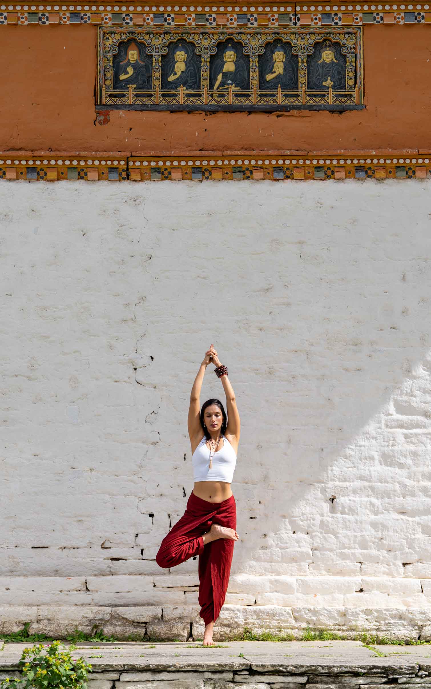 Person performing yoga outdoors in a serene Bhutanese landscape